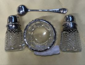 Glass salt and pepper pots with hallmarked silver tops, mustard dish with hallmarked silver rim