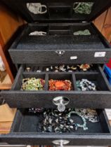 A large jewellery box containing mostly vintage jewellery, various stone necklaces, silver ring,