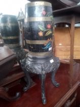 A Chinese black lacquer plant stand together with a bargeware barrel.