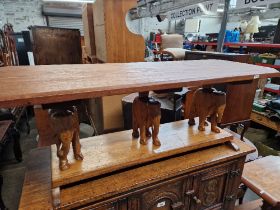 An carved hardwood elephant table.