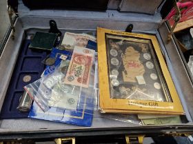 A case of assorted world coins and banknotes