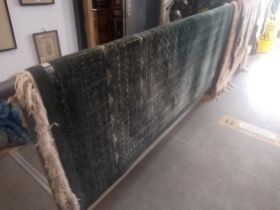 A large Middle Eastern Bokhara style wool carpet, green ground, 375cm x 284cm (approx)