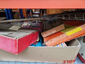 A box of vintage toys and games together with a wooden castle type building.