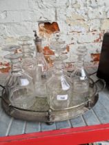 A plated galleried tray with 6 decanters.