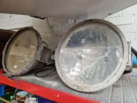 A pair of large industrial Philips spotlights.