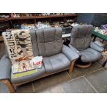 An Ekornes Stressless grey leather two seater sofa and matching swivel armchair.