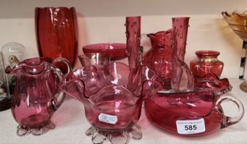 12 pieces of cranberry glass including a fluted jug by Fenton