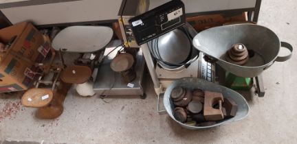 A collection of vintage weighing scales and weights together with two electric shop scales.