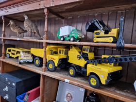 A collection of five Tonka toys.