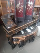 A chinoiserie black lacquer and gilt decorated desk.