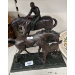 Two bronze effect sculptures of horses
