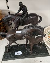 Two bronze effect sculptures of horses