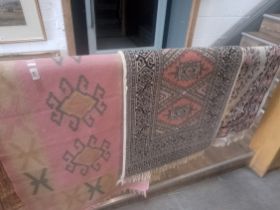 Three small pink ground Eastern style carpets.