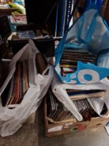 A collection of vinyl records and CDs.