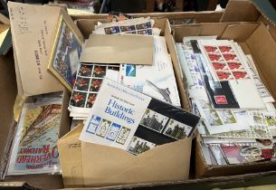 A box of stamps and first day covers etc. Stamps include mint packs