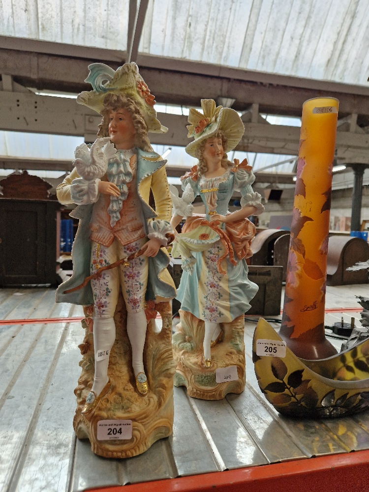 A pair of continental bisque figures.