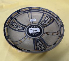 An early Poole Pottery shallow dish painted in pale blue and amber with segmented panels and