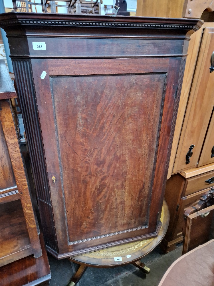 A Georgian mahogany corner cabinet.