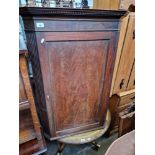 A Georgian mahogany corner cabinet.