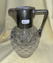 A silver plated and cut glass claret jug in the manner of Christopher Dresser.