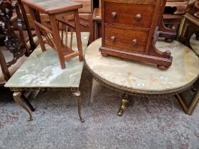 Two brass and onyx top coffee tables and a gilt framed mirror.