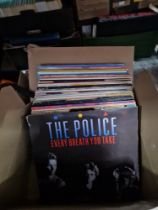 A box of vinyl LP records, various artists, mostly rock and pop.