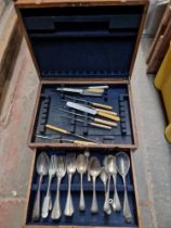 An oak canteen of silver plated cutlery and a vintage radio.