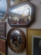 A Regency style convex mirror and a 1930s oak framed mirror.