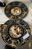 Two large Majolica platters featuring classical figures on blue and brown ground. Diameter appx 39.5