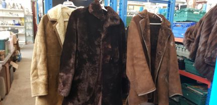 Two sheepskin coats and another coat.