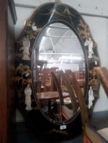 A Chinese black lacquer and gilt decorated mirror with mother of pearl relief figures.