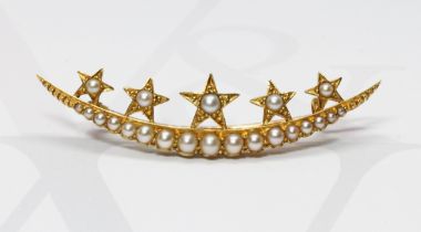 An Edwardian yellow metal split pearl crescent and stars brooch, length 52mm, gross weight 5.5g.