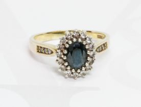 A hallmarked 9ct gold diamond and sapphire cluster ring, gross weight 3.6g, size N.