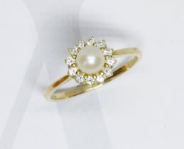 A pearl and diamond cluster ring, the round cluster measuring approximately 10mm in diameter,