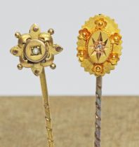 Two antique stick pins; one set with a diamond and marked '18ct', the other set with a seed pearl