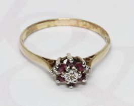 A hallmarked 9ct gold diamond and ruby cluster ring, the cluster measuring approximately 9.57mm x