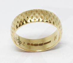 An 18ct gold wedding band, D section band with exterior pattern, sponsor 'BW&SL', London 1970,
