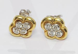 A pair of hallmarked 18ct two colour gold diamond cluster earrings, the cluster measuring