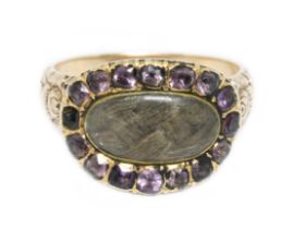 A Scottish(?) Georgian mourning ring, central oval panel of plaited hair behind an oval colourless