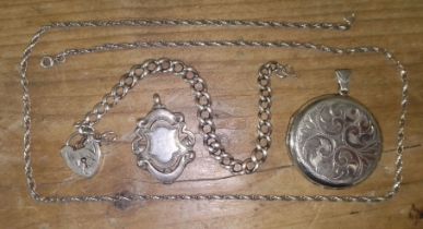 A mixed lot of silver comprising a fob, a bracelet and a locket on chain.