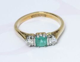 An emerald and diamond ring, the central square stone measuring approximately 4mm x 4mm, depth 3.