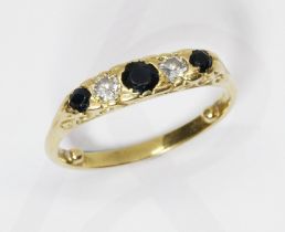 A five stone diamond and sapphire ring, scroll setting, yellow metal band unmarked, gross weight 4.