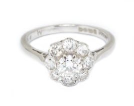 A mid 20th century diamond cluster ring, the central stone weighing approximately 0.43 carats,