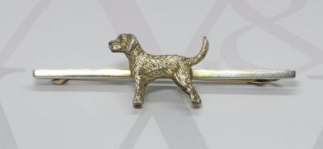A novelty silver bar brooch mounted with a dog, sponsor 'GWL&Co', Birmingham 1938, length 62mm.