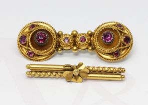 An Edwardian bar brooch marked '15ct' weight 3g, together with a Victorian yellow metal brooch set