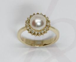 A cultured pearl and diamond cluster ring, the full pearl measuring approximately 8mm in diameter,
