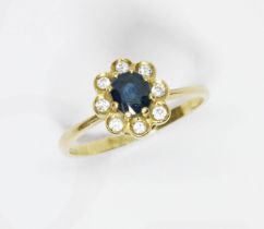 An 18ct gold diamond sapphire cluster ring, the flower head cluster measuring approximately 10.