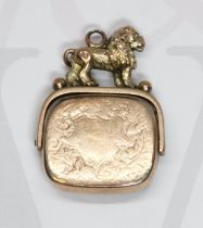 A hallmarked 9ct gold bloodstone swivel fob mounted with a lion, length 31mm, gross weight 7.4g.