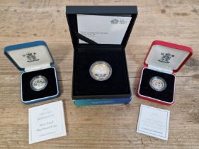 Three UK silver proof coins comprising of a 1999 one pound coin, a 2001 one pound coin and a....