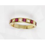 A ruby and diamond half eternity ring, yellow metal band unmarked, gross weight 4.4g, size O.